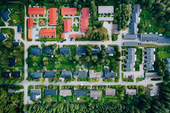 Fotografi taget direkt ovanifrån av villakvarteret Olkahinen i Tammerfors. Bilden visar cirka 30 olika storlekar och färger av tak ordnade i ett ganska klart rutnät, samt korsande gator och grönområden mellan husen.